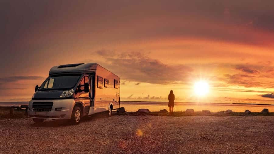 istock-camper-zonsondergang-vrouw-strand-1