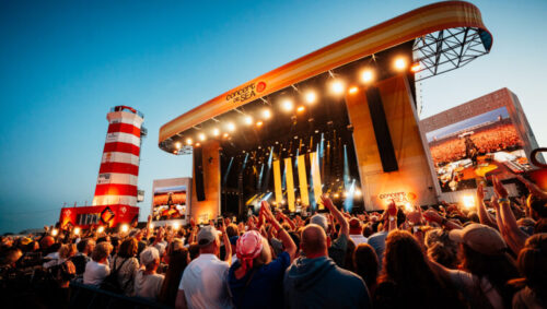 Podium van Concert at SEA met veel mensen die naar optreden kijken