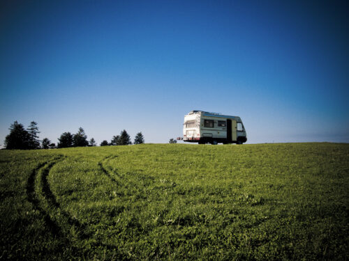 Beeld ter illustratie - camper op groene weide